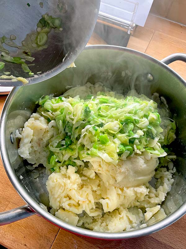 Mixing mash potato with cabbage