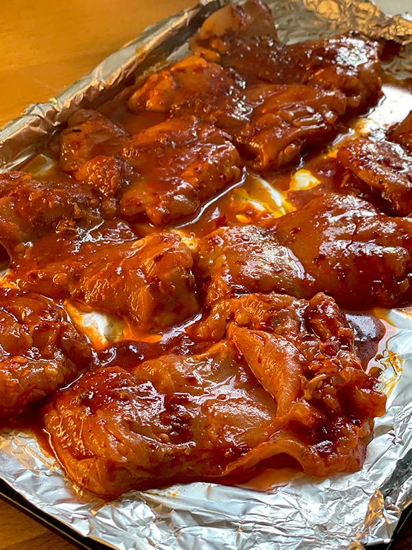 Spicy sticky chicken mixed with harissa and honey marinade