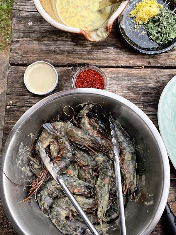 Marinating prawns with lemon, garlic and chilli sauce