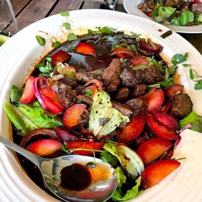 Shaking beef with a plum and watercress salad