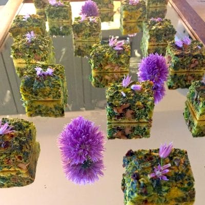 Herb frittata canapé on mirror tray