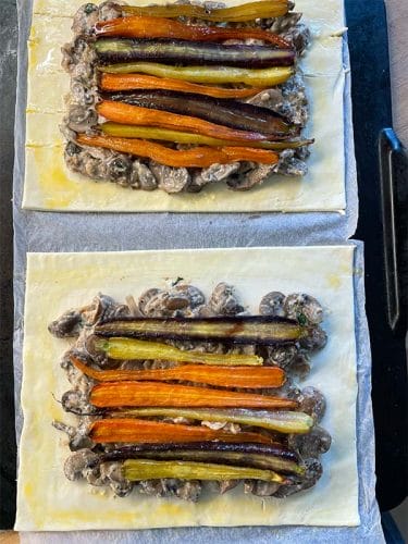 Carrots and mushrooms spread over pastry sheets