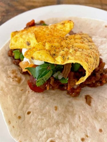Chilli on a soft wrap with tortilli chips