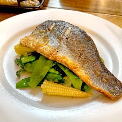 Pan fried sea bass with steamed vegetables and a herb butter