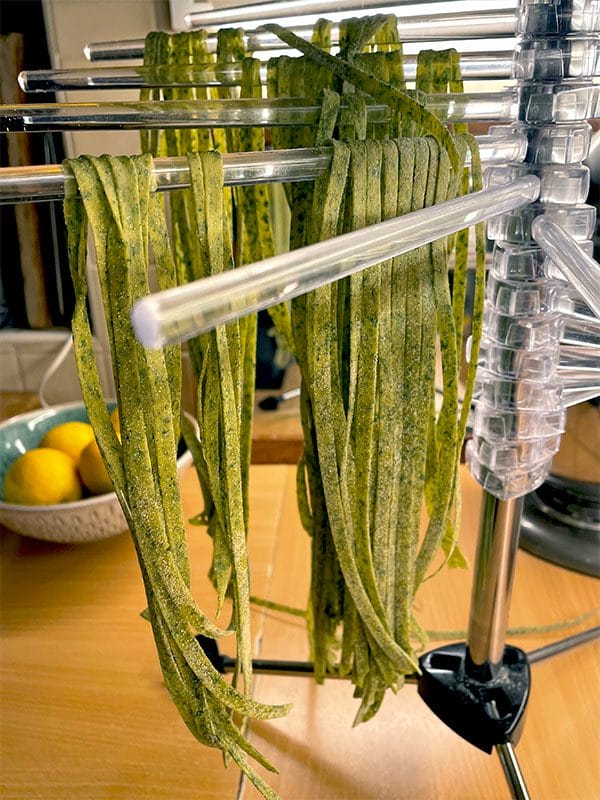 Spinach pasta dough cut into linguine strips