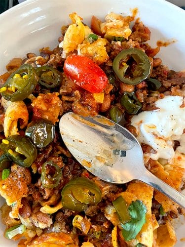 Corn chip pie served with cowboy candy chillis