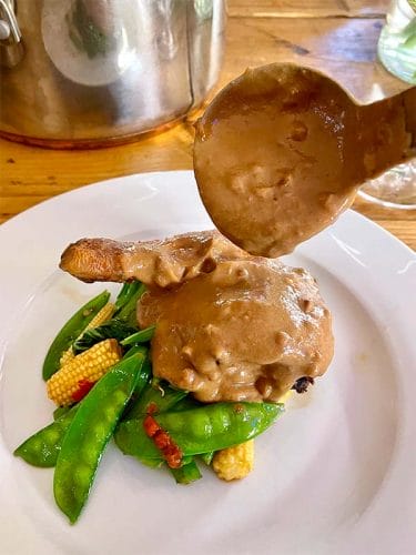 Ladle satay sauce over the chicken to serve